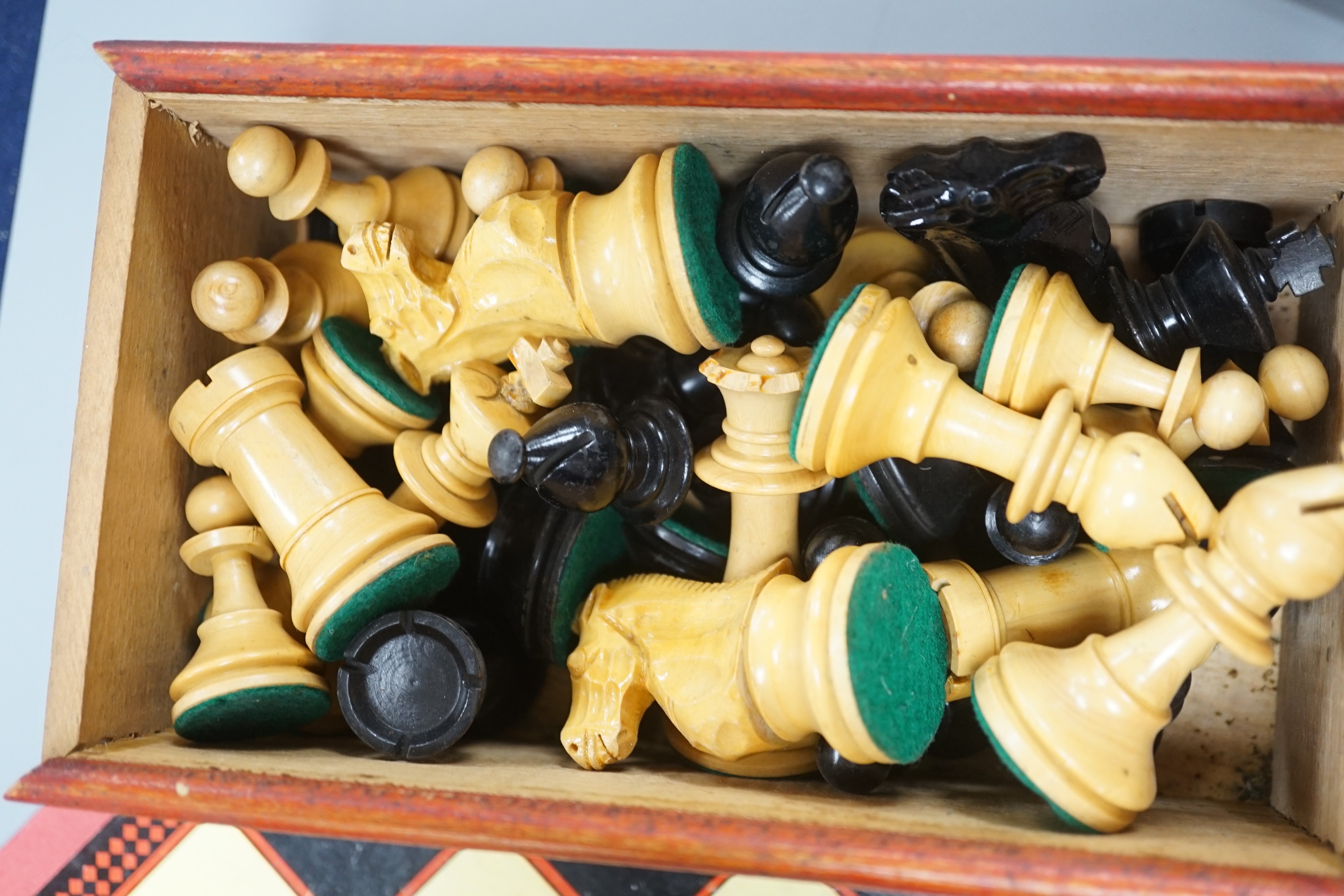 A wooden Staunton chess set and board